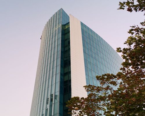 A modern commercial building facade located in Santiago de Chile representing the office area